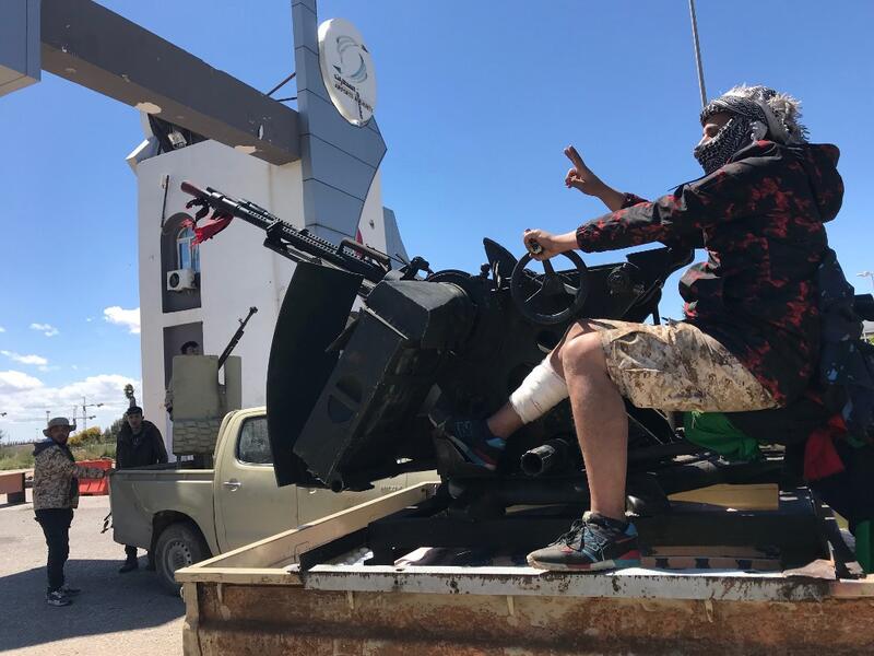 Forces loyal to the internationally recognised Libyan Government of National Accord (GNA) are pictured at the entrance gate leading to Tripoli's old airport on April 8, 2019. Mahmud TURKIA / AFP
