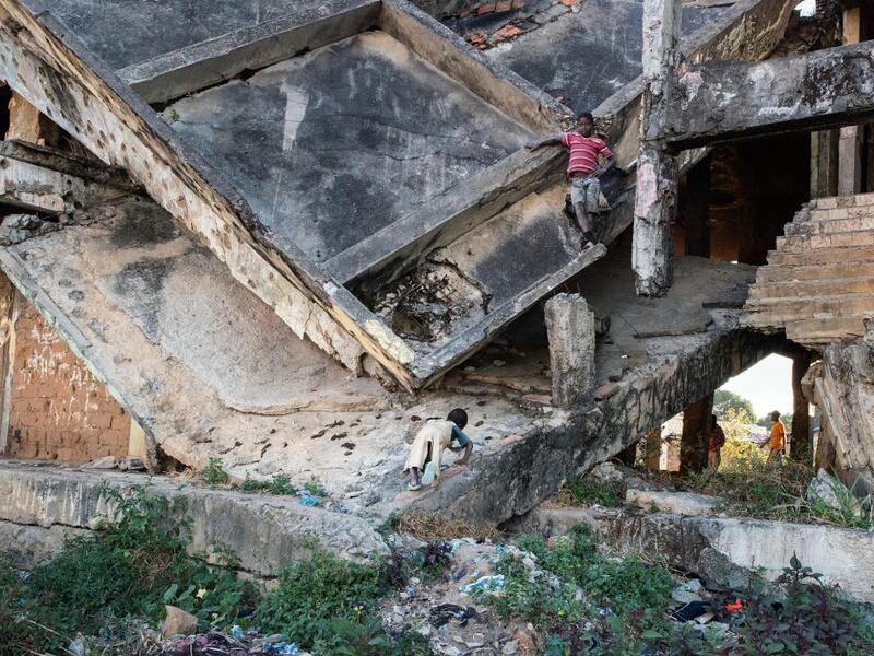 Children play on a derelict building, damaged during the Angolan civil war, in Kuito, Bie Province in central Angola. RODGER BOSCH / AFP