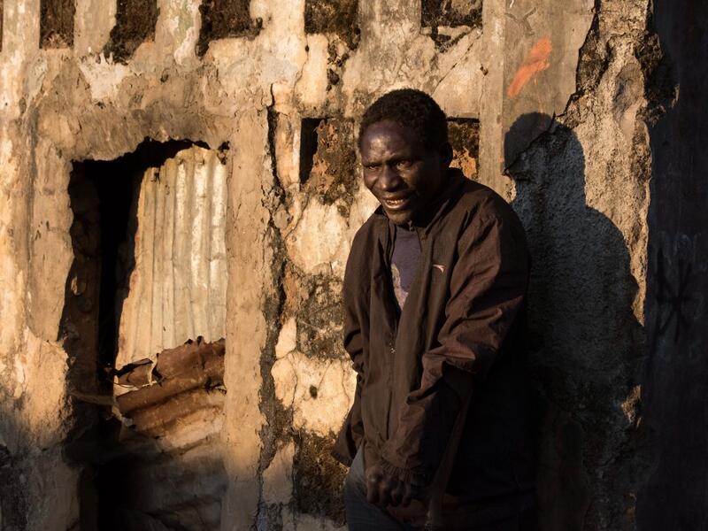 Domingo Tomas, a former soldier with the Angolan Army and now part of a group of homeless people living in a building damaged during the Angolan civil war.  RODGER BOSCH / AFP