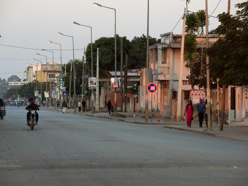 Motorcycles drive down a road in Kuito, Bie Province in Angola RODGER BOSCH / AFP