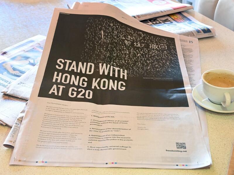This photo illustration shows an advert placed in the national daily newspaper The Australian in Melbourne on June 28, 2019 by a Hong Kong campaign group calling for solidarity with Hong Kong protesters demanding the withdrawal of a bill that would allow extraditions to the Chinese mainland, ahead of the G20 summit in Japan.  William WEST / AFP