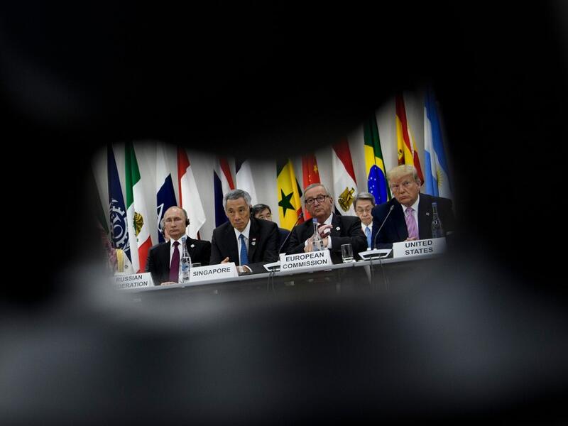 (from left) Russia's President Vladimir Putin, Singapore's Prime Minister Lee Hsien Loong, President of the European Commission Jean-Claude Juncker and US President Donald Trump listen during a meeting at the G20 Summit in Osaka on June 28, 2019.  Brendan Smialowski / AFP