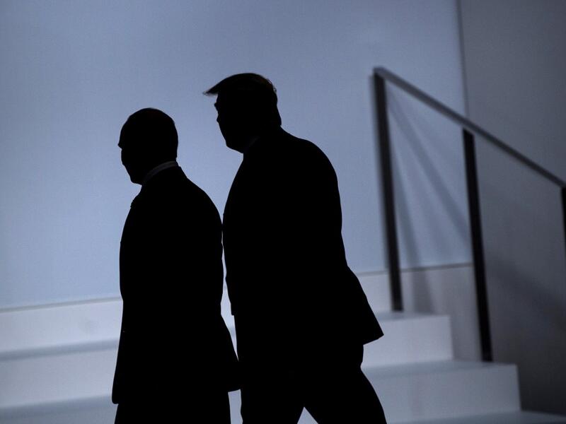 Russia's President Vladimir Putin (L) and US President Donald Trump arrive for a group photo at the G20 Summit in Osaka on June 28, 2019.  Brendan Smialowski / AFP