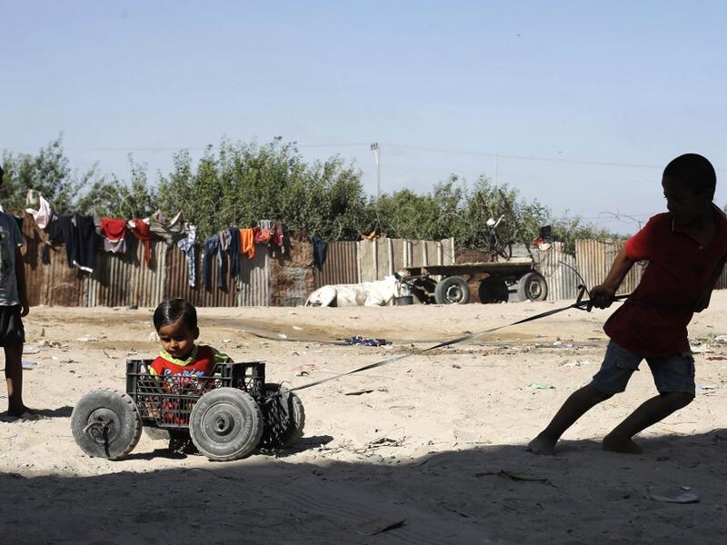 Palestinian children play at an impoverished neighbourhood in Gaza City on July 4, 2019.  MOHAMMED ABED / AFP