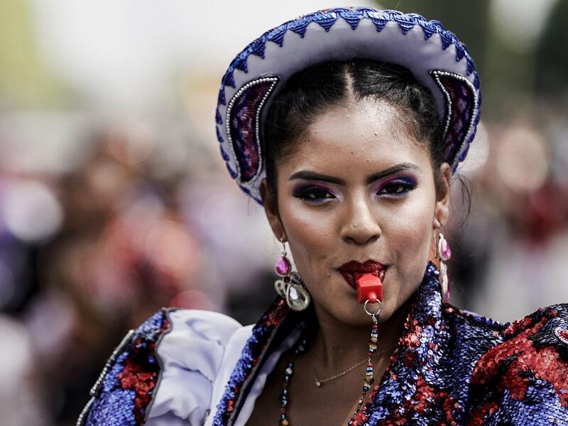 People parade during the Tropical Carnival on July, 7 2019 in Paris.  Kenzo TRIBOUILLARD / AFP