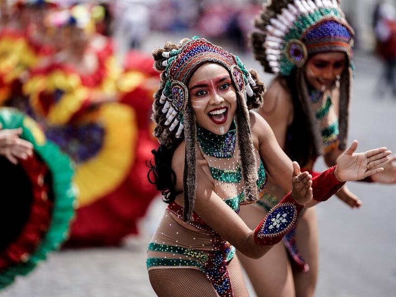 People parade during the Tropical Carnival on July, 7 2019 in Paris.  Kenzo TRIBOUILLARD / AFP