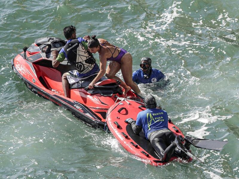 Rescuers assist a cliff diver after jumping off a platform on the landmark Raouche sea rock off the coast of the Lebanese capital Beirut on July 14, 2019, during the 2019 Red Bull Cliff Diving World Series.  ANWAR AMRO / AA / AFP