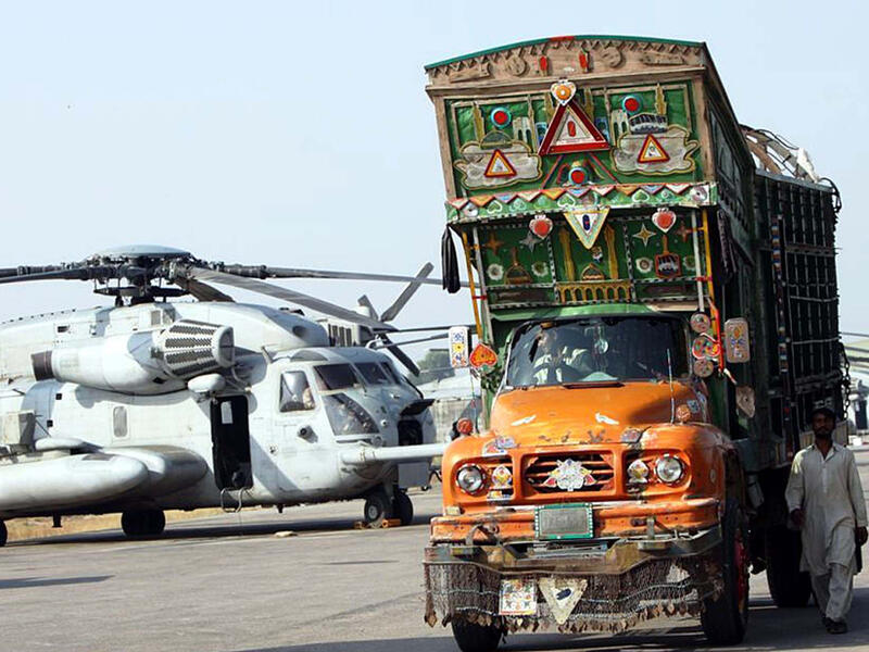 Truck departs Cantt after transferring humanitarian supplies to US military helicopter on a recent mission in Pakistan's flood  (Shutterstock)