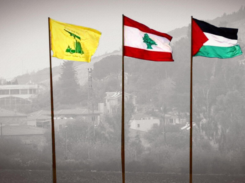The flags of Lebanon’s Hezbollah resistance movement (L), Lebanon (C), and Palestine flying near the southern Lebanese village of Kfar Kila /AFP