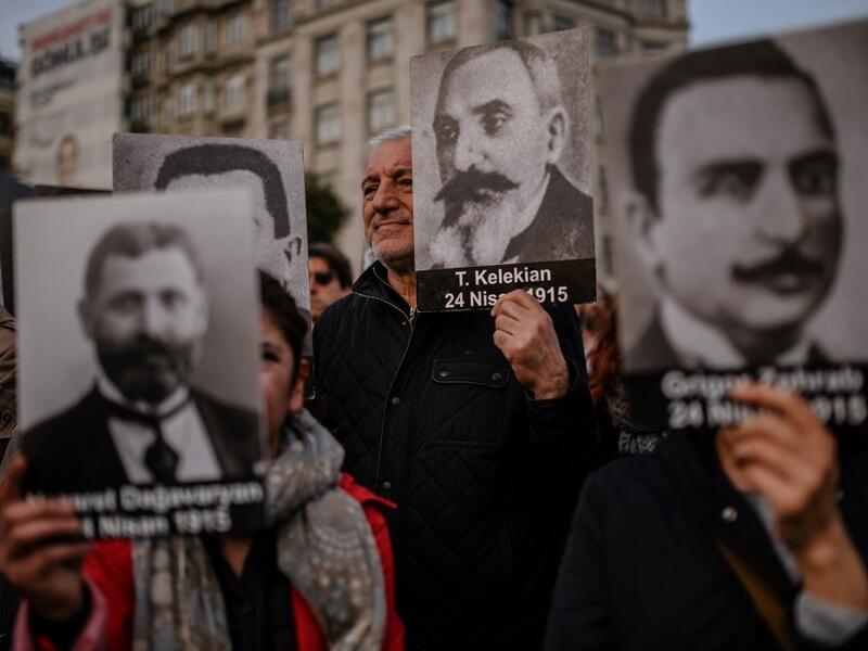 People hold portraits of Armenian intellectuals - who were detained and deported in 1915 - during a rally held to commemorate the 104th anniversary of the 1915 mass killings of Armenians in the Ottoman Empire near Istiklal avenue at Sishane square in Istanbul on April 24, 2019. BULENT KILIC / AFP