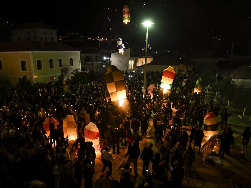 Colorful lanterns lift into in the night sky of Leonidio, a seaside town in the Peloponnese, to mark the Ressurection of Christ celebrated by the Greek Orthodox Church on April 28, 2019.  ARIS MESSINIS / AFP