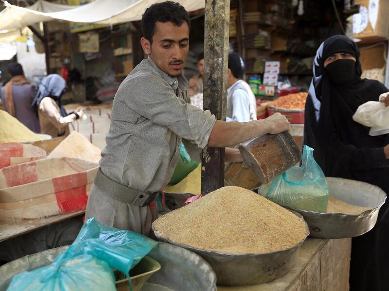 A Yemeni vendor sells grain in a market in the old city of the capital Sanaa, as the faithful prepare for the Muslim holy fasting month of Ramadan, on May 2, 2019. Mohammed HUWAIS / AFP