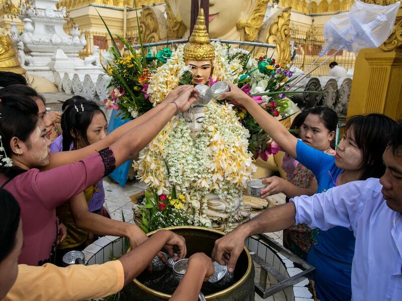 Buddhist devotees pour water at Shwedagone pagoda during Buddha's birthday which falls on the Full Moon Day of Kasone in Yangon, on May 18, 2019.  Sai Aung MAIN / AFP