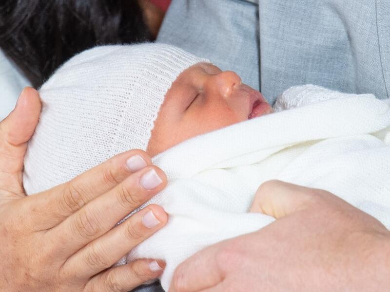 Britain's Prince Harry, Duke of Sussex (R), and his wife Meghan, Duchess of Sussex, pose for a photo with their newborn baby son, Archie Harrison Mountbatten-Windsor, in St George's Hall at Windsor Castle in Windsor, west of London on May 8, 2019.  Dominic Lipinski / POOL / AFP