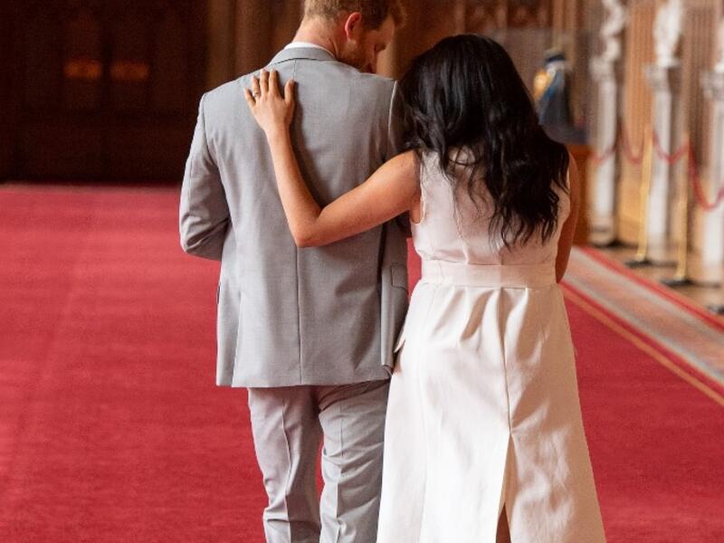 Britain's Prince Harry, Duke of Sussex (L), and his wife Meghan, Duchess of Sussex, walk away after posing for photographs with their newborn baby son, Archie Harrison Mountbatten-Windsor, in St George's Hall at Windsor Castle in Windsor, west of London on May 8, 2019.  Dominic Lipinski / POOL / AFP