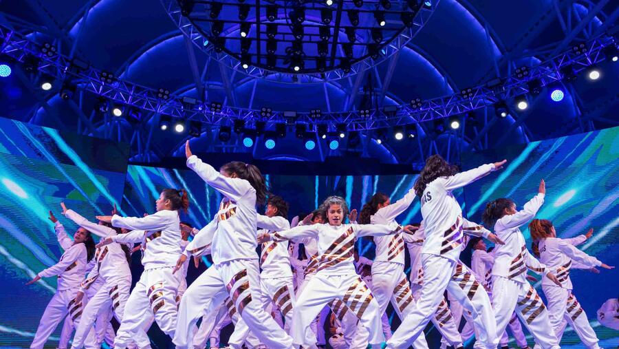 بعد النجاح العالمي في برنامج المواهب الأمريكية، فرقة "ڤي-أنبيتابل"  تتحدى قوانين الجاذبية في القرية العالمية