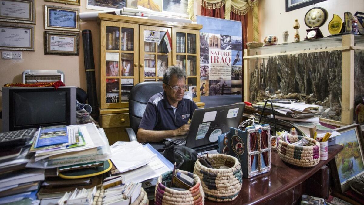 Jassim al-Assadi, director of Nature Iraq, an environmental activist group advocating for long-term ecotourism planning better protection for the Iraqi marshes, sits at his office in the southern district of Chibayish in Dhi Qar province. Hussein FALEH / AFP