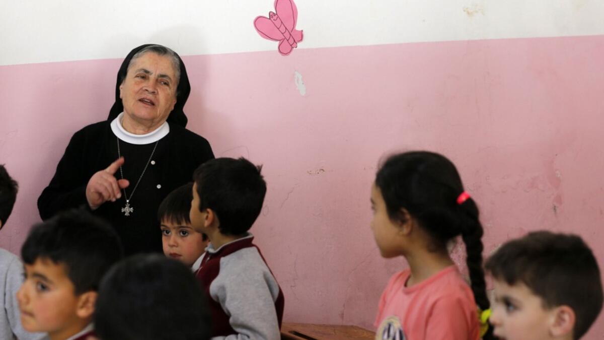 Angel Allam, a nun and teacher instructs her students in the Aramaic language, the biblical language of Jesus, at a school in the mountain village of Maalula, in Syria's Damascus region on May 13, 2019. LOUAI BESHARA / AFP