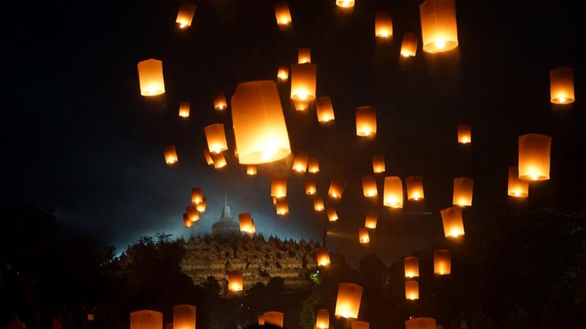 Buddhist devotees release lanterns into the air as a symbol of peace to honour Buddha's birthday, also known as Vesak celebrations, at Borobudur temple in Magelang, Central Java, early on May 19 2019. OKA HAMIED / AFP