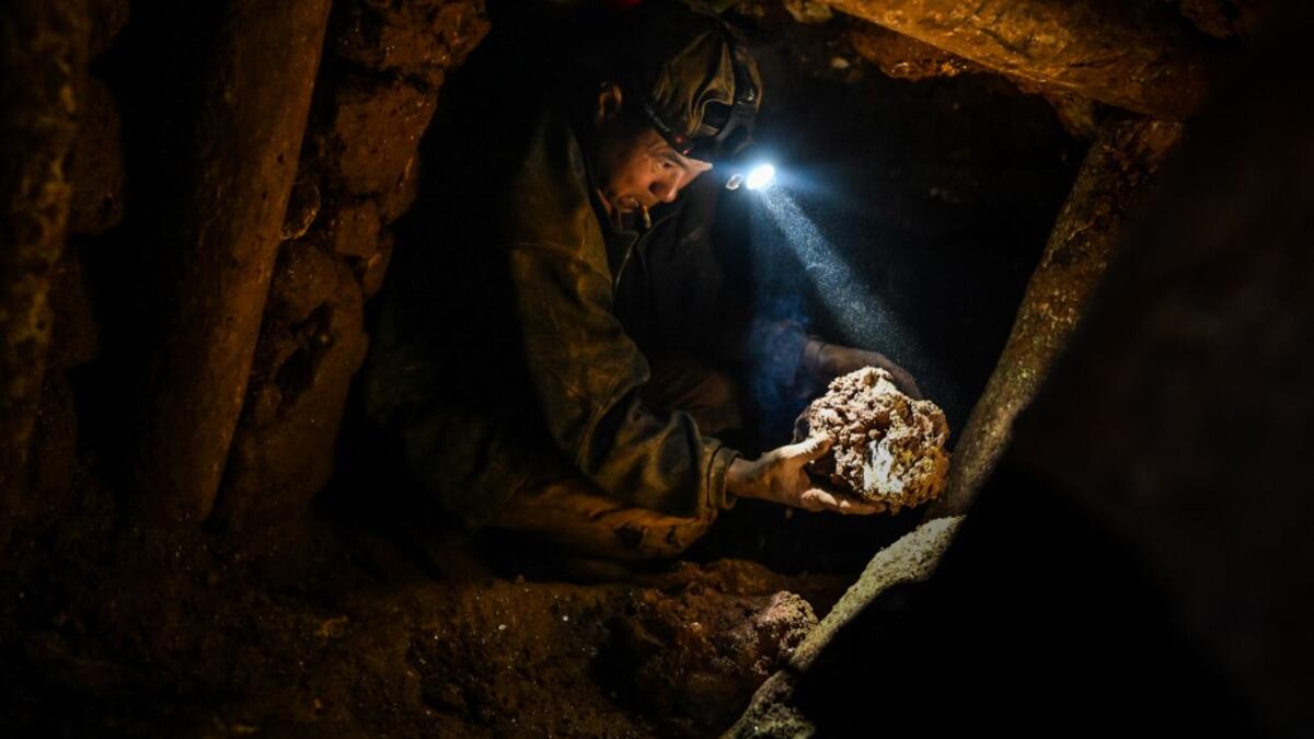 This photo taken on May 16, 2019 shows a miner working in a tunnel in a ruby mine in Mogok, north of Mandalay. Burrowing deep underground, thousands of informal miners risk their lives to find gleaming red gems as a law change spurs opportunity in Myanmar's "land of rubies". Ye Aung THU / AFP