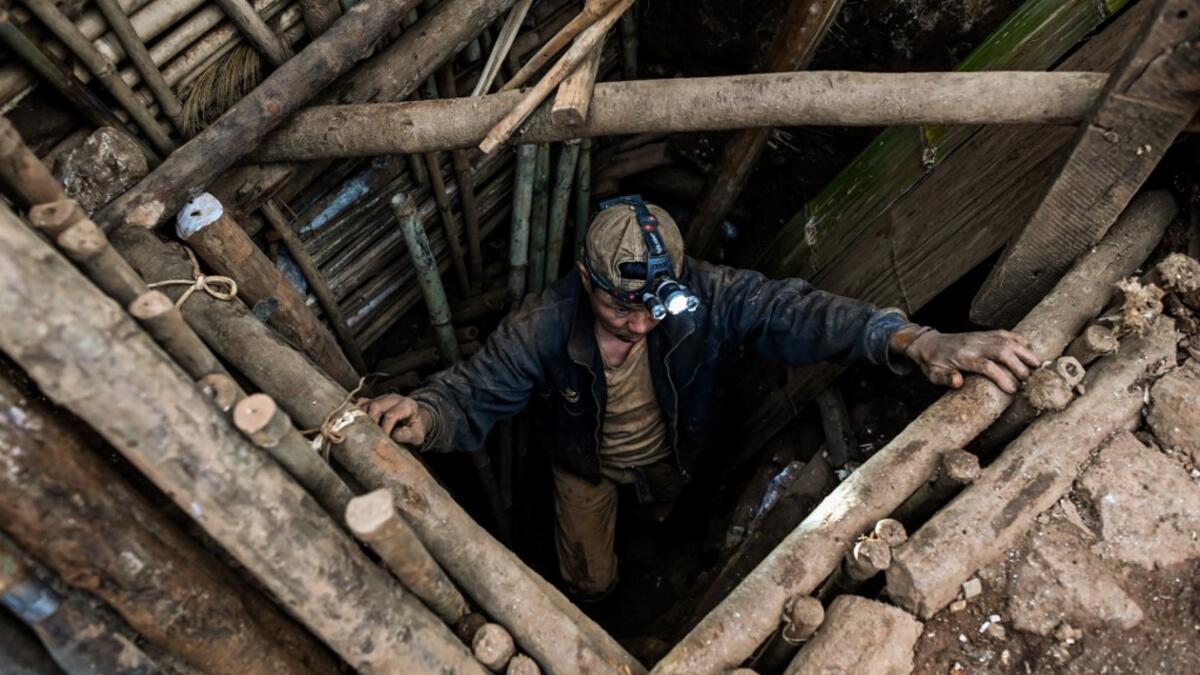This photo taken on May 16, 2019 shows a miner entering a tunnel in a ruby mine in Mogok, north of Mandalay. Burrowing deep underground, thousands of informal miners risk their lives to find gleaming red gems as a law change spurs opportunity in Myanmar's "land of rubies". Ye Aung THU / AFP