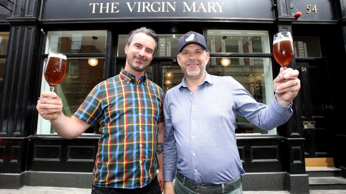 Pub co-owners Oisin Davis (L) and Vaughan Yates pose outside the Virgin Mary pub, which opened recently selling non-alcoholic drinks and is known as the 'pub with no beer', in the city centre of Dublin on May 16, 2019. PAUL FAITH / AFP