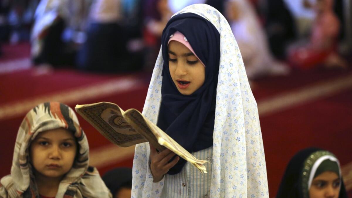 Iraqi children learn to read from the Koran at the shrine of the Sunni Sheikh Abdul Qadir al-Jilani in Baghdad on May 28, 2019, during the holy Muslim month of Ramadan.  AHMAD AL-RUBAYE / AFP