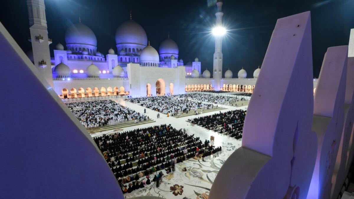 This picture taken early on June 1, 2019 from the crenellations of the Sheikh Zayed Grand Mosque in the UAE capital Abu Dhabi shows Muslim worshippers praying in the mosque's courtyard on the occasion of Lailat al-Qadr. KARIM SAHIB / AFP