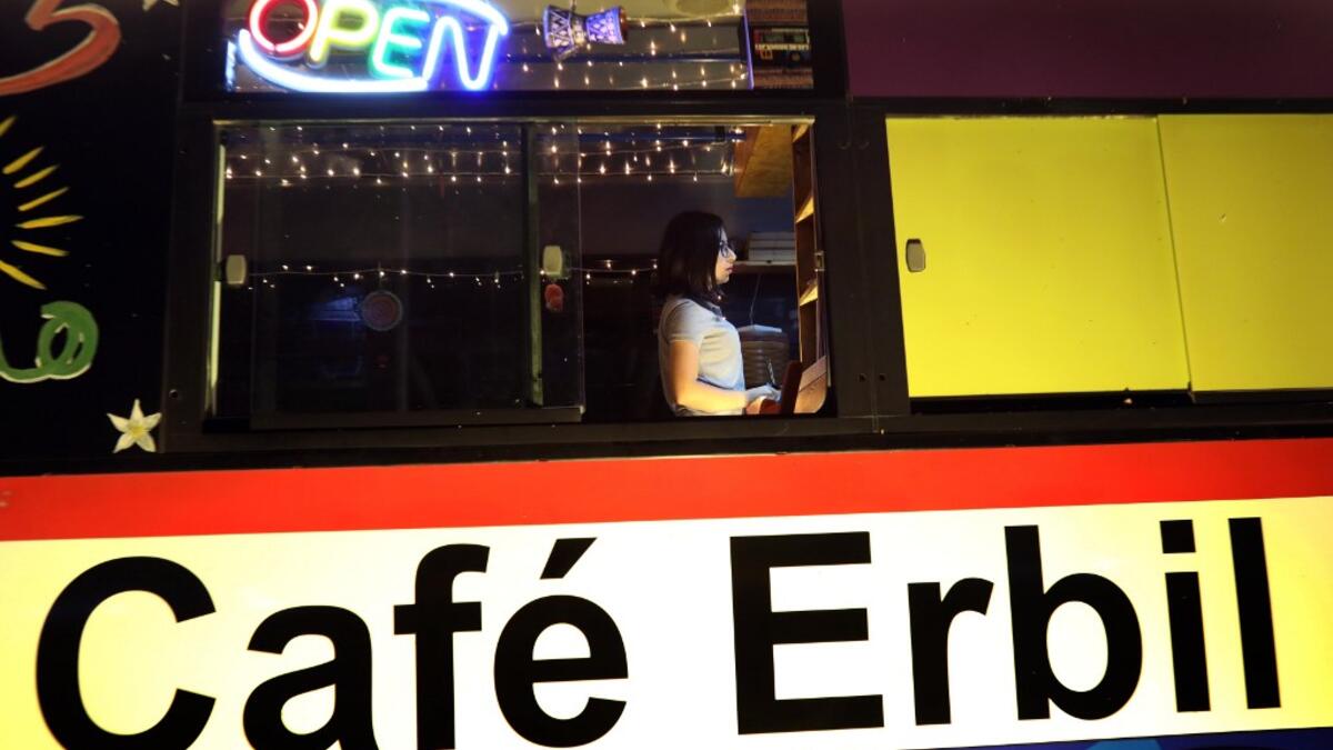 Kani Jalil, a 22-year-old Iraqi Kurdish woman who runs with her husband "The Bus Cafe Erbil" in Arbil, the capital of Iraq's Kurdish autonomous region, is pictured late on June 7, 2019, on the long weekend of the Eid al-Fitr holiday which marks the end of the Muslim holy month of Ramadan.  SAFIN HAMED / AFP