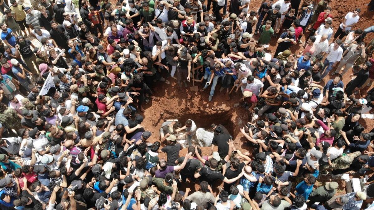 A picture taken with a drone on June 9, 2019 shows Syrians attending the burial of late rebel fighter Abdel-Basset al-Sarout in al-Dana in Syria's jihadist-controlled Idlib region, near the border with Turkey. OMAR HAJ KADOUR / AFP