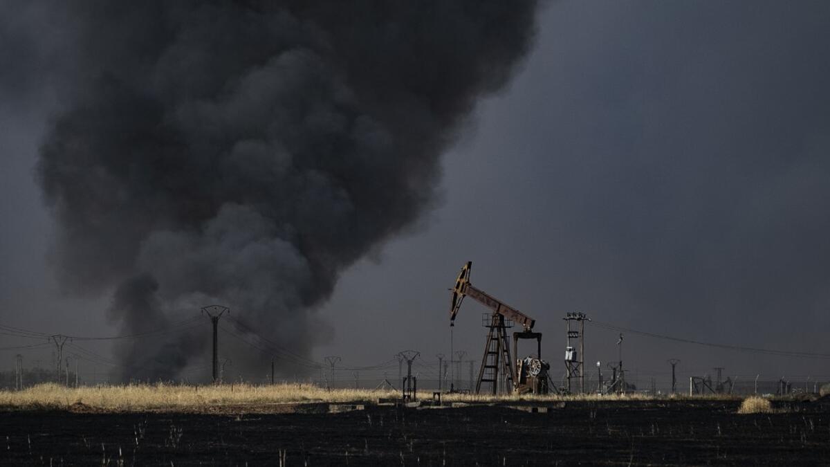 People battle a blaze next to an oil well in an agricultural field in the town of al-Qahtaniyah, in the Hasakeh province near the Syrian-Turkish border on June 10, 2019. Fires have erupted in various parts of Syria in recent weeks, with all sides blaming each other for starting them. Delil souleiman / AFP