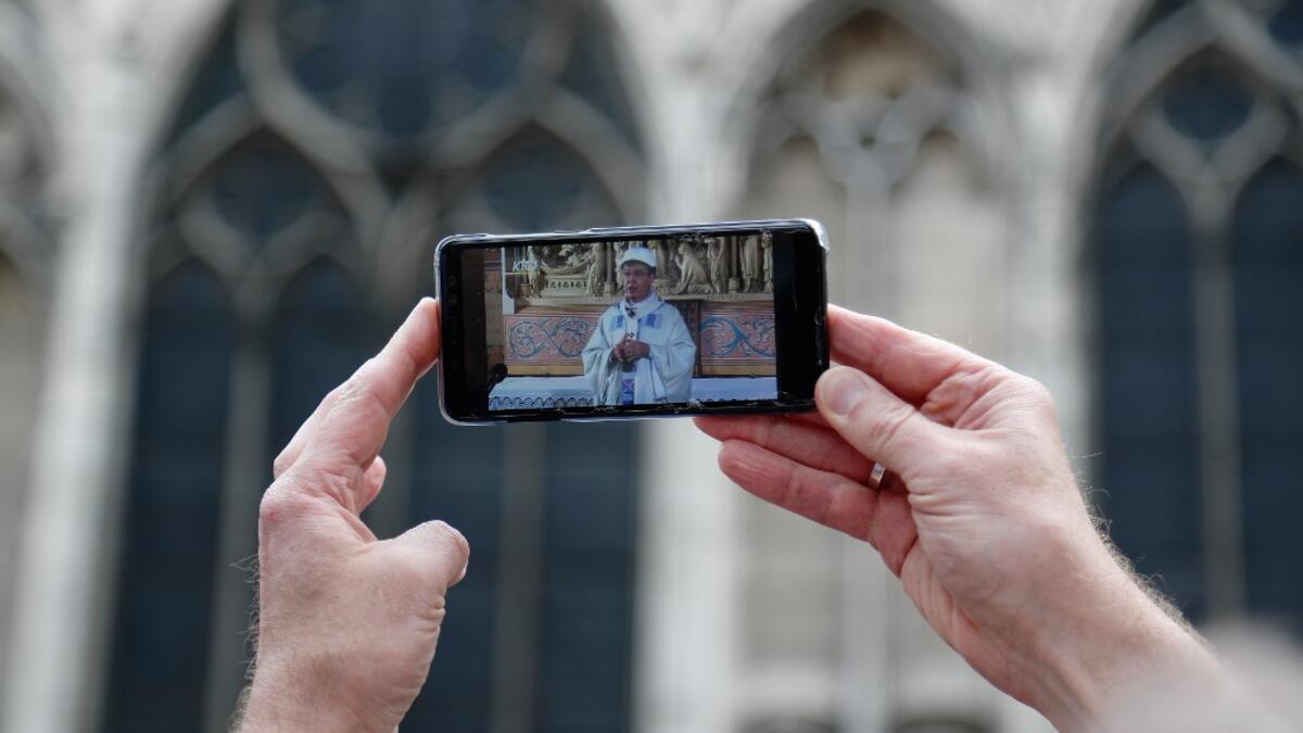 For safety reasons, the mass led by Archbishop of Paris Michel Aupetit will be celebrated on a very small scale. Worshippers will be expected to don hard hats but priests will be wearing their ceremonial garb. Zakaria ABDELKAFI / AFP