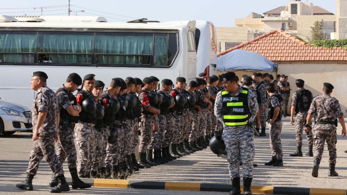 Members of the Jordanian Security forces stand guard outside the US embassy  during the "March of Anger" in the capital Amman on June 21, 2019, against  US President Donald Trump's "Deal of the Century" and the US-led Middle East economic conference in Bahrain.  Khalil MAZRAAWI / AFP