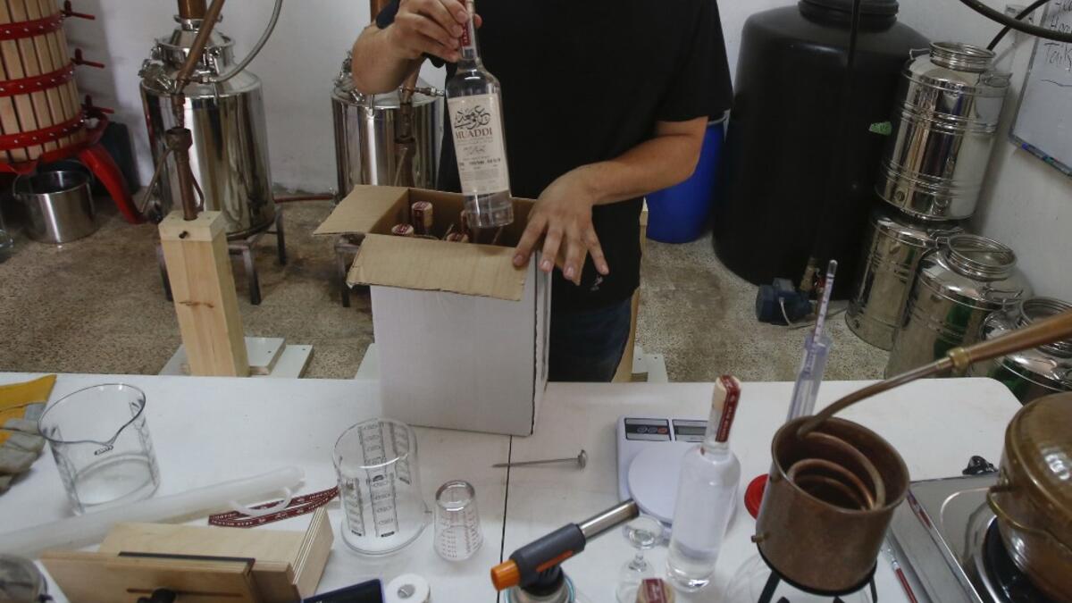 Palestinian distiller Nader Muaddi packages his Arak bottles in the West Bank village of Beit Jala, near Bethlehem, on June 16, 2019. In his basement, distiller Muaddi made fewer than 500 bottles of liquor last year, but it is earning global acclaim and reviving interest in the Palestinian alcohol sector. On the outskirts of the city famed for Jesus's birth, the 35-year-old illustrates the handcrafted way he makes Arak, an anise-flavoured drink popular in the Middle East and similar to Greek Ouzo, French Pa
