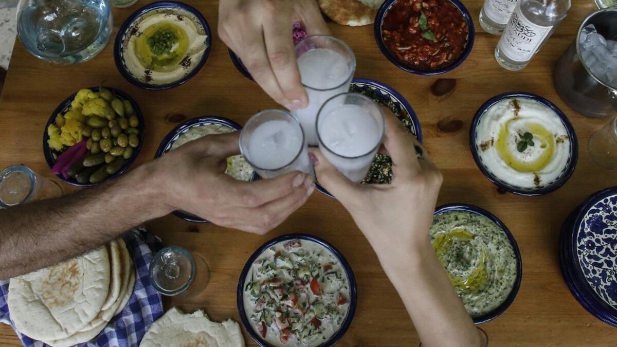 Palestinian distiller Nader Muaddi drinks his handcrafted Arak in the occupied West Bank city of Beit Jala, near Bethlehem, on June 16, 2019. In his basement, distiller Muaddi made fewer than 500 bottles of liquor last year, but it is earning global acclaim and reviving interest in the Palestinian alcohol sector. On the outskirts of the city famed for Jesus's birth, the 35-year-old illustrates the handcrafted way he makes Arak, an anise-flavoured drink popular in the Middle East and similar to Greek Ouzo, F