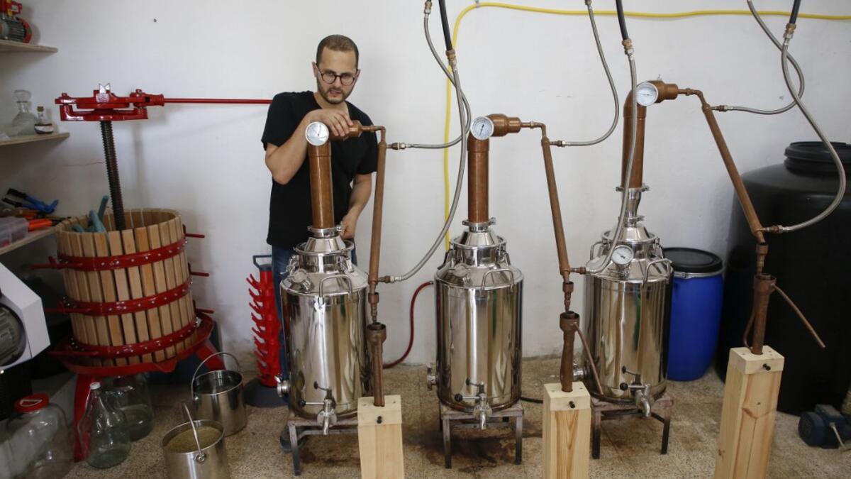 Palestinian distiller Nader Muaddi waits for the alcohol to distill in the West Bank village of Beit Jala, near Bethlehem, on June 16, 2019. In his basement, distiller Muaddi made fewer than 500 bottles of liquor last year, but it is earning global acclaim and reviving interest in the Palestinian alcohol sector. On the outskirts of the city famed for Jesus's birth, the 35-year-old illustrates the handcrafted way he makes Arak, an anise-flavoured drink popular in the Middle East and similar to Greek Ouzo, Fr