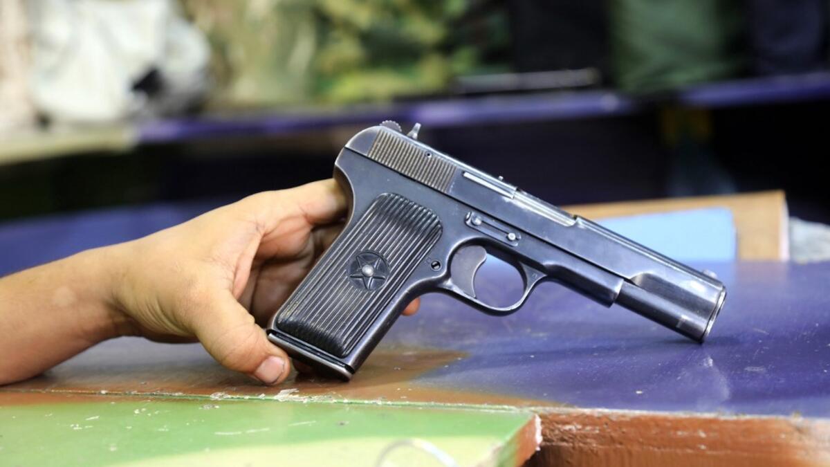 A Soviet-produced TT-33 pistol is pictured at a shop in Yemen's third city of Taez, on July 13, 2019. Before the war, the old market of Taez was crowded with people and full of handcrafts and artisanal goods. Today, more than four years after the Huthi rebels began their siege on Yemen's third largest city, bullets and guns have taken over the market. AHMAD AL-BASHA / AFP