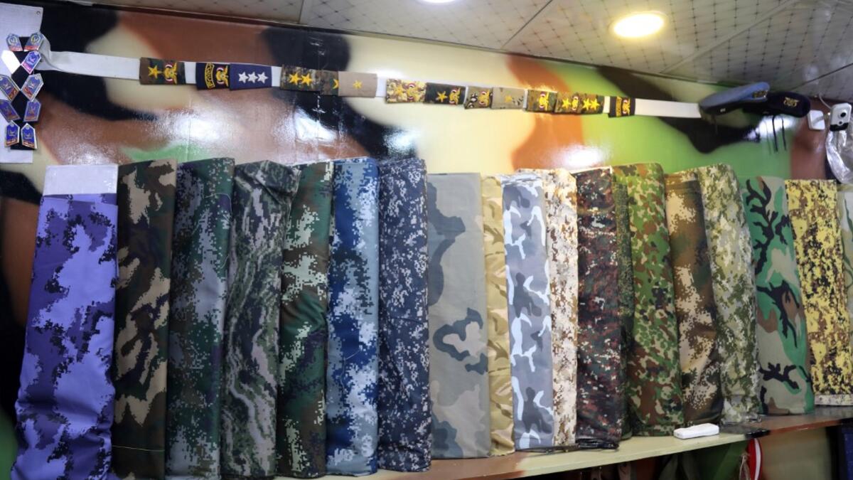 A picture shows military camouflage textiles on display at a shop in Yemen's third city of Taez, on July 13, 2019. AHMAD AL-BASHA / AFP