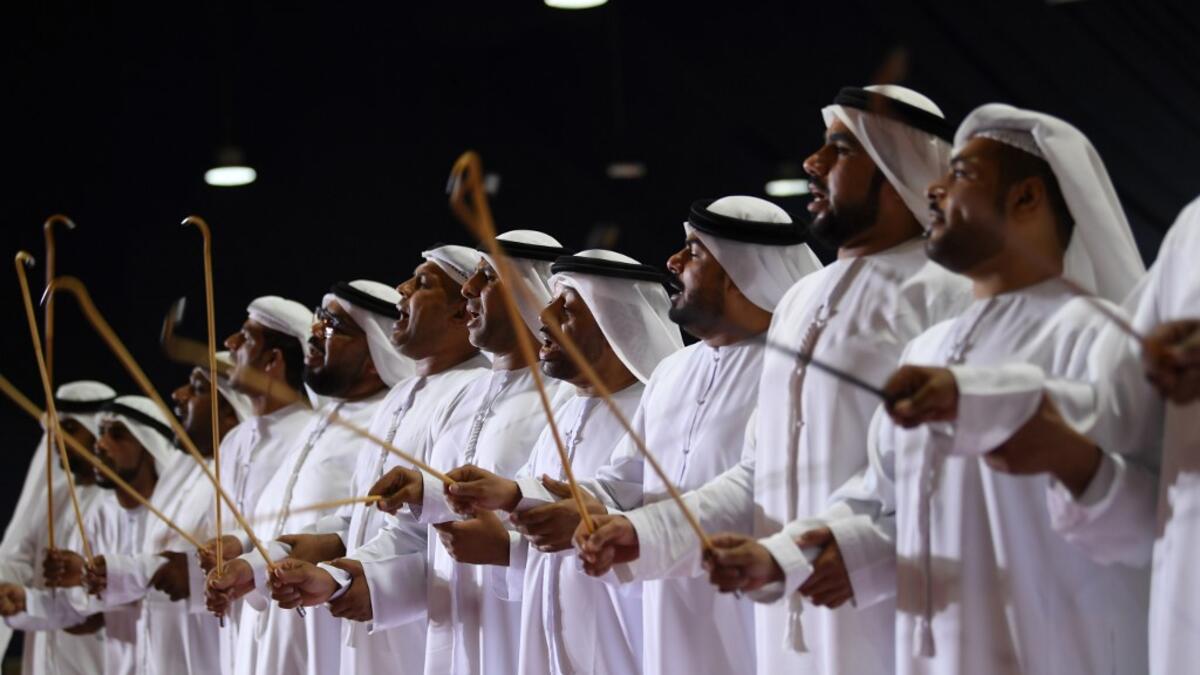 Emirati musicians perform during the annual Liwa Date Festival in the western region of Liwa on July 17, 2019. The Liwa Date Festival aims to preserve Emirati heritage, specifically palm trees and half-ripe dates, knows as "ratab", which are deep-rooted in the Gulf country's traditions. Karim SAHIB / AFP