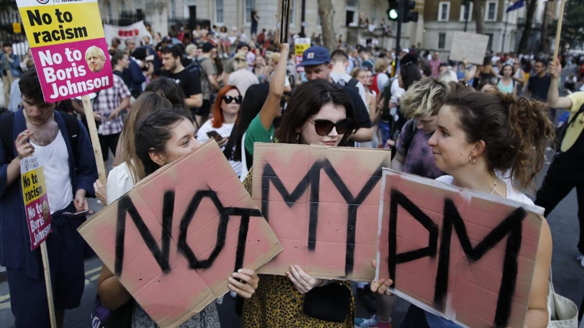 Demonstrators carry placards as they protest against Britain's newly appointed prime minister Boris Johnson outside Downing Street in London on July 24, 2019. Boris Johnson took charge as Britain's prime minister on Wednesday, on a mission to deliver Brexit by October 31 with or without a deal. Tolga AKMEN / AFP / POOL