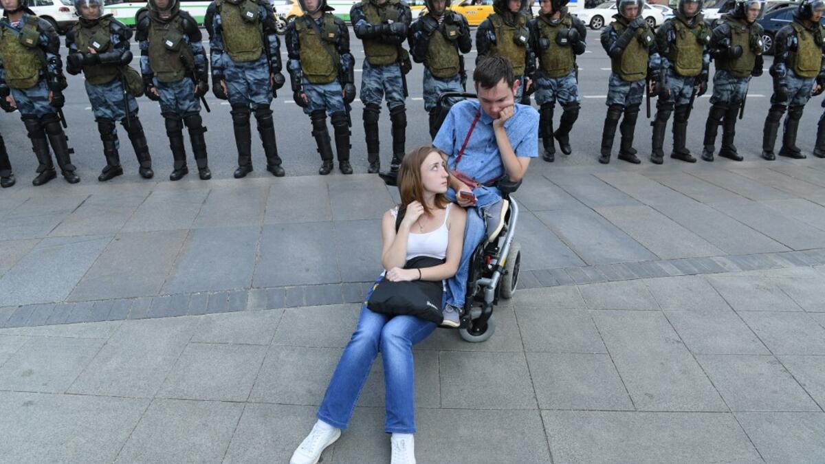Servicemen of the Russian National Guard stand in line along Moscow's Tverskaya street during an unauthorised rally demanding independent and opposition candidates be allowed to run for office in local election in September, in downtown Moscow on July 27, 2019.  Kirill KUDRYAVTSEV / AFP