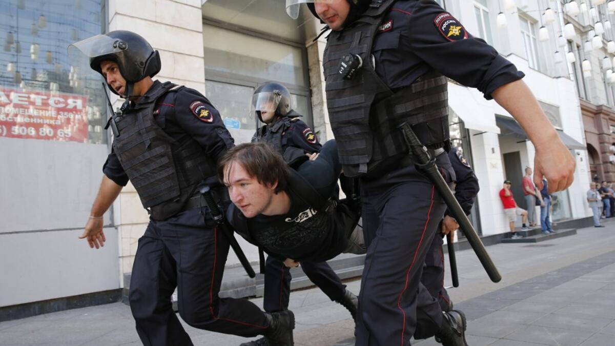 Police officers detain a protester during an unauthorised rally demanding independent and opposition candidates be allowed to run for office in local election in September, in downtown Moscow on July 27, 2019.  Maxim ZMEYEV / AFP
