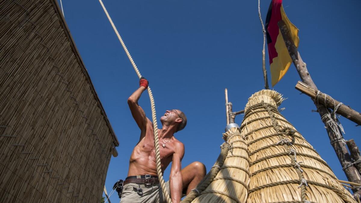 A member of the crew assembles the 14-meter long sailing reed boat Abora IV in the town of Beloslav, Bulgaria, on July 25, 2019. A team of two dozen researchers and volunteers from eight countries are preparing to set out in mid-August on a 1,300 kilometres (700 nautical mailes or 800 miles) journey to test the hypothesis that prehistoric trade routes traversed the high seas. NIKOLAY DOYCHINOV / AFP