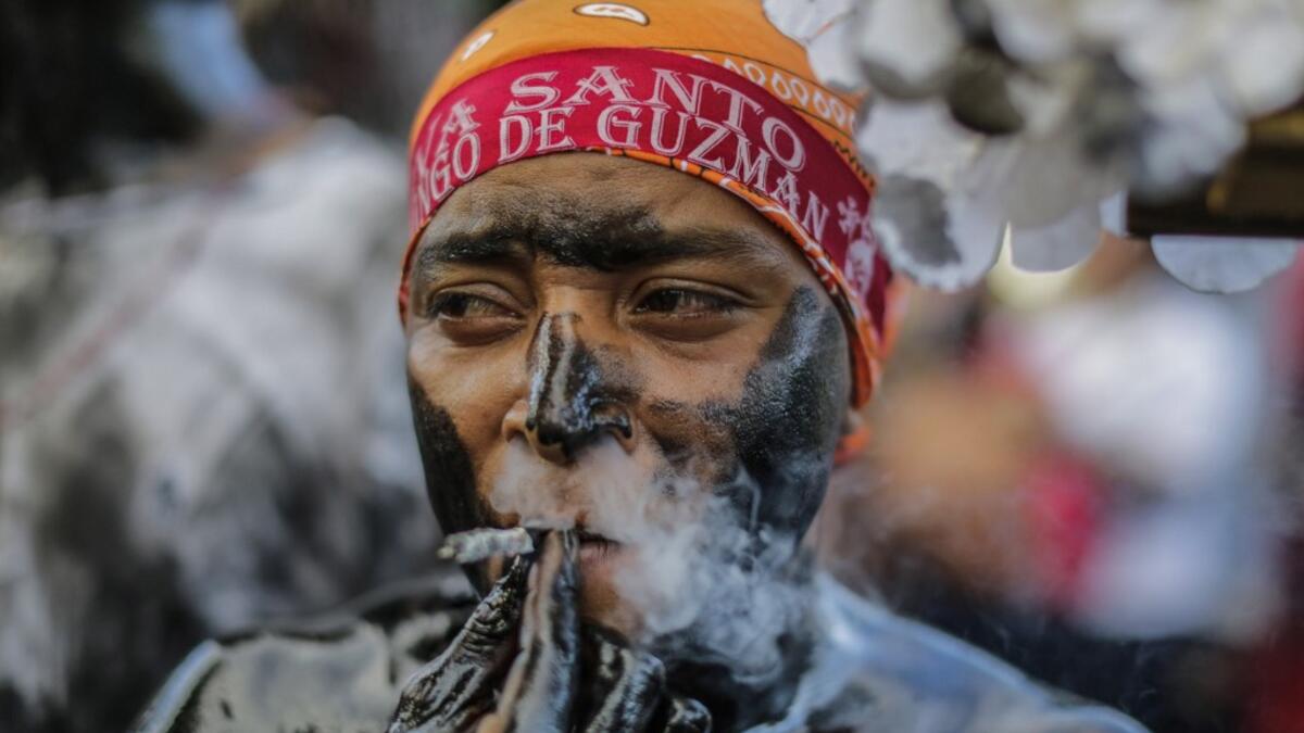A catholic faithful smeared in burnt oil, takes part in the opening of the ten-day celebration of the Santo Domingo de Guzman festival in Managua, on August 1, 2019.  INTI OCON / AFP