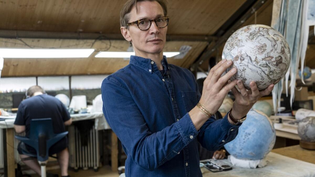 Artisan globemaker, Peter Bellerby poses for a photograph at the Bellerby and Co Globemakers' workshop and headquarters in Stoke Newington in north London, on July 19, 2019. Niklas HALLE'N / AFP