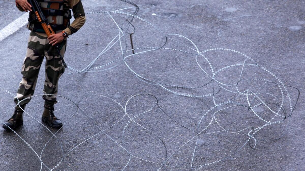 A security personnel stands guard at a roadblock in Jammu on August 7, 2019. A protester died after being chased by police during a curfew in Kashmir's main city, left in turmoil by an Indian government move to tighten control over the restive region, a police official said on August 7. Rakesh BAKSHI / AFP
