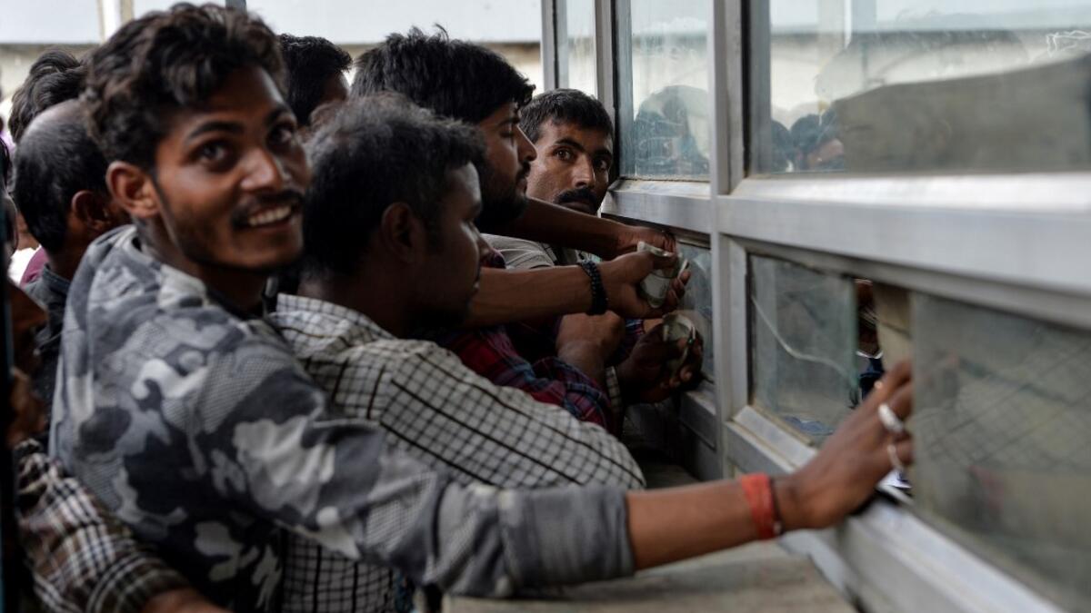 Labourers from across India working in Kashmir buy bus tickets at a counter of Jammu and Kashmir Tourist Reception Centre (JKTRC) to leave the city due to the heightened security situation in Srinagar  Sajjad HUSSAIN / AFP