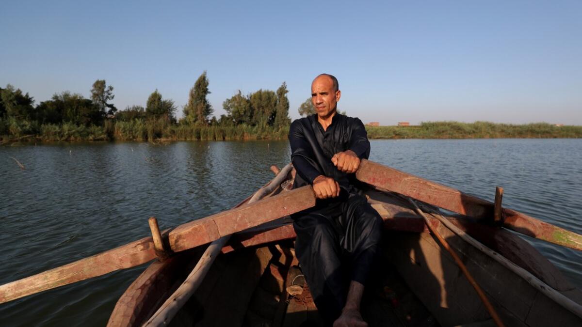 An Egyptian Fisherman sails in the waters of the Pharaonic Sea in the village of Kafr Fisha, province of Monufia, on August 13, 2019. Mohamed el-Shahed / AFP