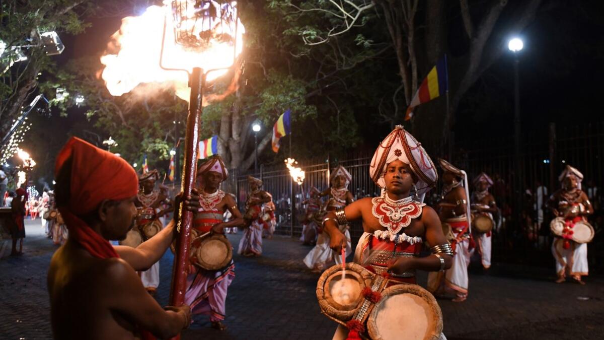 In this photograph taken on August 14, 2019 musicians perform during the "Esala Perahera" festival near the Buddhist temple of the Tooth in the ancient hill capital of Kandy, some 116 kilometres from Colombo. Lakruwan WANNIARACHCHI / AFP
