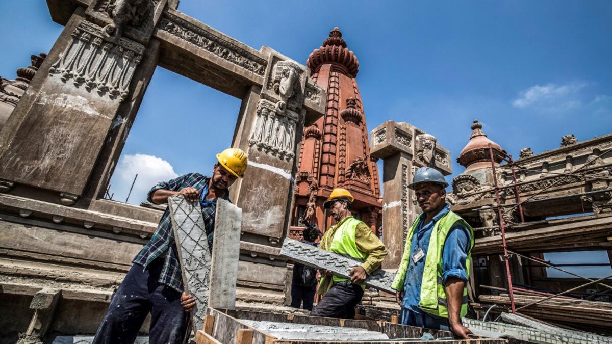 This picture taken on August 18, 2019 shows restoration works ongoing at the historic "Le Palais Hindou" (also known as the "Baron Empain Palace") built by in the early 20th century by Belgian industrialist Edouard Louis Joseph, Baron Empain, in the classical Khmer architectural style of Cambodia's Angkor Wat, in the Egyptian capital Cairo's northeastern Heliopolis district.  Khaled DESOUKI / AFP